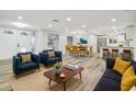 Bright and open floor plan showcases modern furnishings, hardwood floors, and an open transition into the dining area at 7804 N Whittier St, Tampa, FL 33617