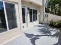 Exterior view of the side entry with patio, exterior light, and well-maintained landscaping at 8707 Sailmaker Ct, Tampa, FL 33615