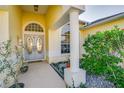 Covered front porch and entry to this beautiful home with lush landscaping at 8833 Bel Meadow Way, Trinity, FL 34655