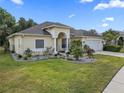 Beautiful single-story home featuring a well-maintained lawn, mature landscaping, and attached two car garage at 8833 Bel Meadow Way, Trinity, FL 34655