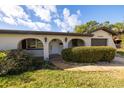 Front exterior of a charming home showcasing a welcoming entrance with manicured greenery and attached garage at 1032 26Th S Ave, St Petersburg, FL 33705