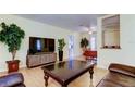 Comfortable living room with a sleek TV and modern media center, open to the dining area at 10514 52Nd N Ave, St Petersburg, FL 33708