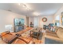Spacious living room with hardwood floors, a large TV, comfortable couches, and stylish decor at 1313 E Cayuga St, Tampa, FL 33603
