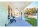 Inviting front porch with ample seating area, perfect for relaxing and enjoying the neighborhood views at 1313 E Cayuga St, Tampa, FL 33603