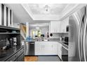Modern kitchen with granite countertops, stainless steel appliances, and white cabinetry at 14019 Notreville Way, Tampa, FL 33624