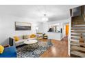 Bright living room featuring stylish decor and hardwood floors, creating a welcoming atmosphere at 14019 Notreville Way, Tampa, FL 33624