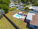 Expansive backyard featuring a pristine pool, patio furniture, and lush green lawn at 1541 68Th N Ave, St Petersburg, FL 33702