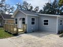Charming single-story house showcasing a welcoming front porch and a well-maintained lawn at 1574 Ewing Ave, Clearwater, FL 33756