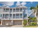 Charming multi-story condo with balconies, garages, and lush tropical landscaping at 16306 1St E St, Redington Beach, FL 33708