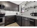 Modern kitchen with stainless steel appliances, sleek cabinets, and quartz countertops at 1998 Blue Hawk Ct # 1613, Clearwater, FL 33762