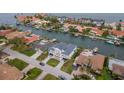Aerial view of a waterfront neighborhood with homes, canals, boats, and beautifully landscaped yards at 2050 Hawaii Ne Ave, St Petersburg, FL 33703