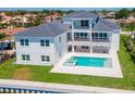 Beautiful backyard featuring a modern pool, jacuzzi, patio, and manicured lawn, perfect for outdoor living at 2050 Hawaii Ne Ave, St Petersburg, FL 33703