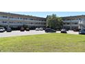 Exterior view of condo building, with a lawn in front and a parking area at 2284 Philippine Dr # 41, Clearwater, FL 33763