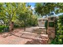 Elegant gated community entrance with brick signage and lush greenery at 2920 W El Prado Blvd # 4, Tampa, FL 33629