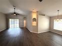 Open-concept living room with lots of natural light and stylish ceiling fan at 3138 Clover Blossom Cir, Land O Lakes, FL 34638