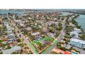 Aerial view of a charming neighborhood street showcasing lush landscaping and well-maintained homes at 4151 Belle Vista Dr, St Pete Beach, FL 33706