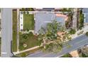 Aerial view of a home highlighting the well-manicured lawn, a patio, mature trees and lush landscaping at 4151 Belle Vista Dr, St Pete Beach, FL 33706