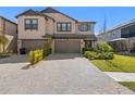 A well-maintained house with lush landscaping and an attractive paver driveway, side of the house at 4600 Lagona Ln, Wesley Chapel, FL 33543