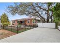 Beautiful single-story brick home featuring an expansive driveway and fenced yard at 5010 45Th N Ave, St Petersburg, FL 33709
