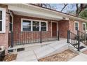 A welcoming brick porch with railings offers a cozy entrance to the home at 5010 45Th N Ave, St Petersburg, FL 33709