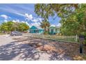 Exterior view of cottage-style homes with well-maintained landscaping and a white picket fence, a great curb appeal at 5314 21St S Ave, Gulfport, FL 33707