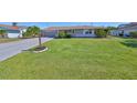 Charming single-story home with a well-maintained lawn and a two car garage with driveway at 607 Fox Hills Dr, Sun City Center, FL 33573