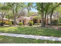 Inviting home with a well-manicured lawn and mature trees, offering a serene and picturesque setting at 6109 Kingbird Manor Dr, Lithia, FL 33547