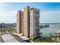 Modern high-rise building featuring balconies, ample parking, and waterfront views at 7300 Sun Island S Dr # 202, South Pasadena, FL 33707