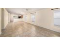 Spacious living room with tile flooring, large windows, and access to the kitchen at 7924 Carriage Pointe Dr, Gibsonton, FL 33534