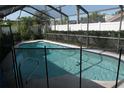 Relaxing screened-in pool area surrounded by a fence, offering privacy and an inviting outdoor space at 8609 Thimbleberry Ln, Tampa, FL 33635