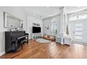 Inviting living room features wood floors, shiplap accent wall, and a large window for natural light at 1002 Romano Ne Ct, St Petersburg, FL 33702