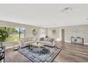Bright living room with hardwood floors, neutral decor, and plenty of natural light at 12006 Glenshire Dr, Riverview, FL 33579