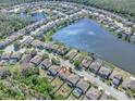Aerial view of lakefront community highlighting the home's location near waterfront and community amenities at 1218 Halapa Way, Trinity, FL 34655
