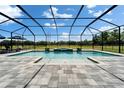 A stunning screened-in pool area with a water feature and plenty of space for outdoor lounging at 14239 Swiss Bridge Dr, Riverview, FL 33579