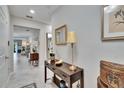 Hallway featuring a console table with decorative lamps and a framed mirror at 16927 April Plush Dr, Wimauma, FL 33598