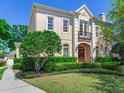 Charming two-story home with landscaped yard, elegant architectural details and a welcoming entrance at 2927 W Bayshore Ct, Tampa, FL 33611