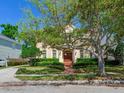 Inviting two-story home with manicured landscaping, featuring a classic design and a warm, welcoming facade at 2927 W Bayshore Ct, Tampa, FL 33611