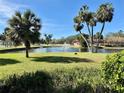 Scenic pond with a fountain, surrounded by lush landscaping and palm trees at 3001 58Th Ave S # 1103, St Petersburg, FL 33712