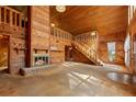 Spacious living room with a fireplace, open staircase to the second floor, and abundant natural light at 308 N Smokey Mountain Rd, Seffner, FL 33584