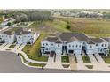 Aerial view of townhomes showcases the community layout with manicured landscaping and convenient parking at 3138 Victoria Inlet Dr, Holiday, FL 34691