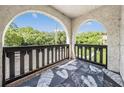 A private balcony offers a view of the surrounding trees and green space at 320 N Bayshore Blvd # 208, Clearwater, FL 33759