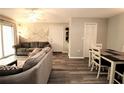 The living room features modern vinyl plank flooring, a ceiling fan, and neutral paint at 320 N Bayshore Blvd # 208, Clearwater, FL 33759