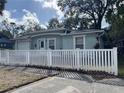 Attractive single-story home with white picket fence, and tidy front yard at 3211 E 23Rd Ave, Tampa, FL 33605