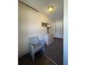 Neutral hallway featuring a decorative vase on cabinet, and a wicker chair at 3211 E 23Rd Ave, Tampa, FL 33605
