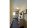 Inviting hallway featuring a mirror, decorative vase, neutral paint, and ceiling light fixture at 3211 E 23Rd Ave, Tampa, FL 33605
