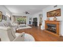 Bright living room boasts hardwood floors, fireplace and sliding glass door leading to the lanai at 4206 Preserve Pl, Palm Harbor, FL 34685