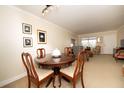 Dining area showcasing a round table with chairs, adjacent to a well-lit living room at 4910 Bay Ne St # 308, St Petersburg, FL 33703