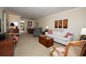 Cozy living room with traditional furniture, neutral color scheme, and view into dining area at 4910 Bay Ne St # 308, St Petersburg, FL 33703