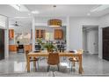 Bright dining room featuring a modern chandelier, skylights, an open floorplan, and views of the kitchen at 4925 Camellia S Way, St Petersburg, FL 33705