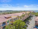 Stunning aerial view of condos with red tile roof, offering gorgeous waterfront views and convenient parking at 5000 Culbreath Key Way # 8-308, Tampa, FL 33611